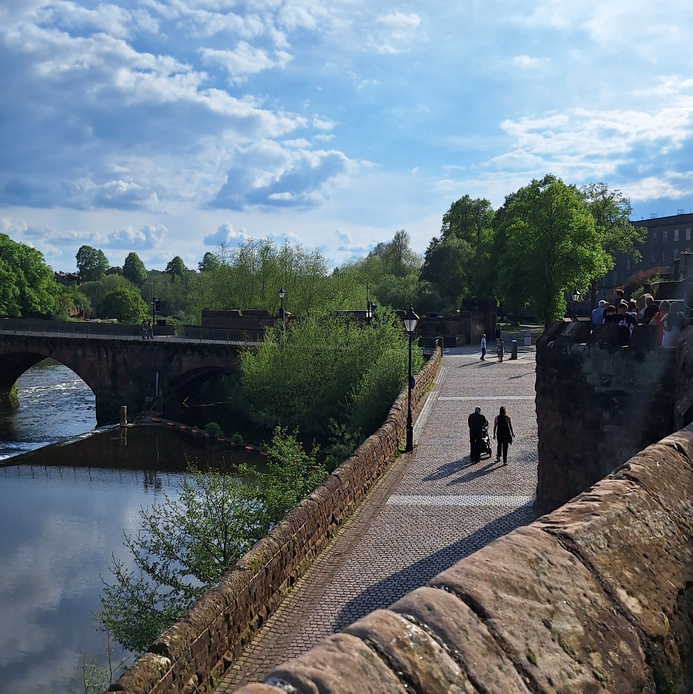 A cobbled stone walkway alongside the River Dee in Chester. The view is from Chester's Roman walls.