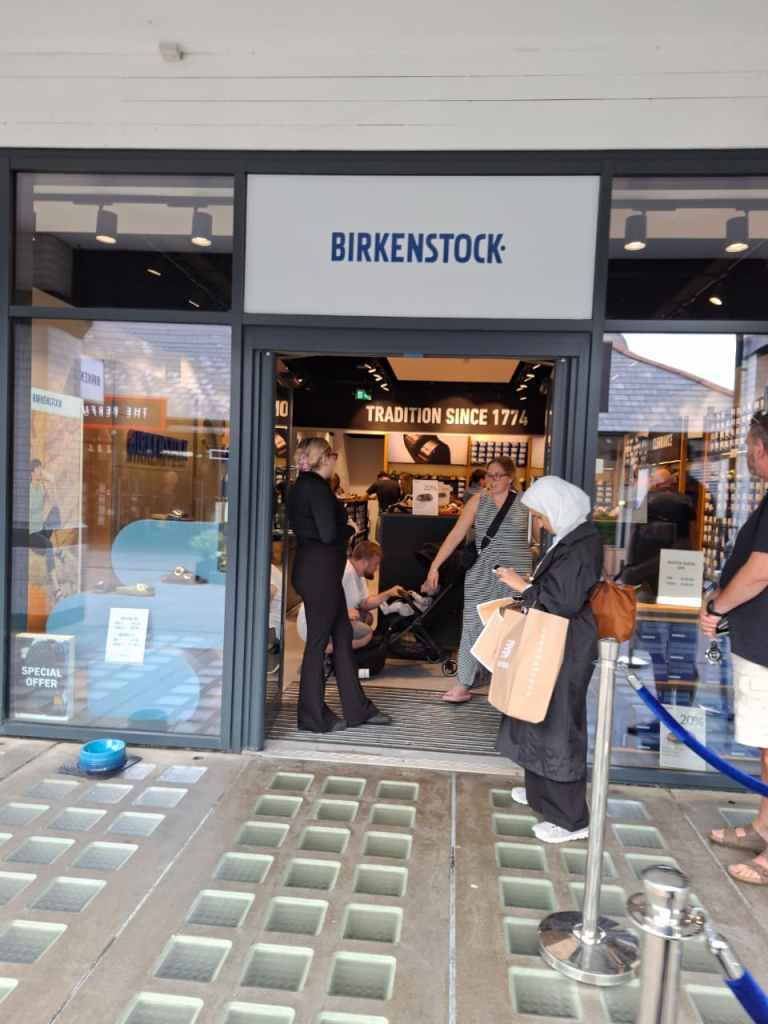 A queue outside the Birkenstock store at Cheshire Oaks outlet village.
